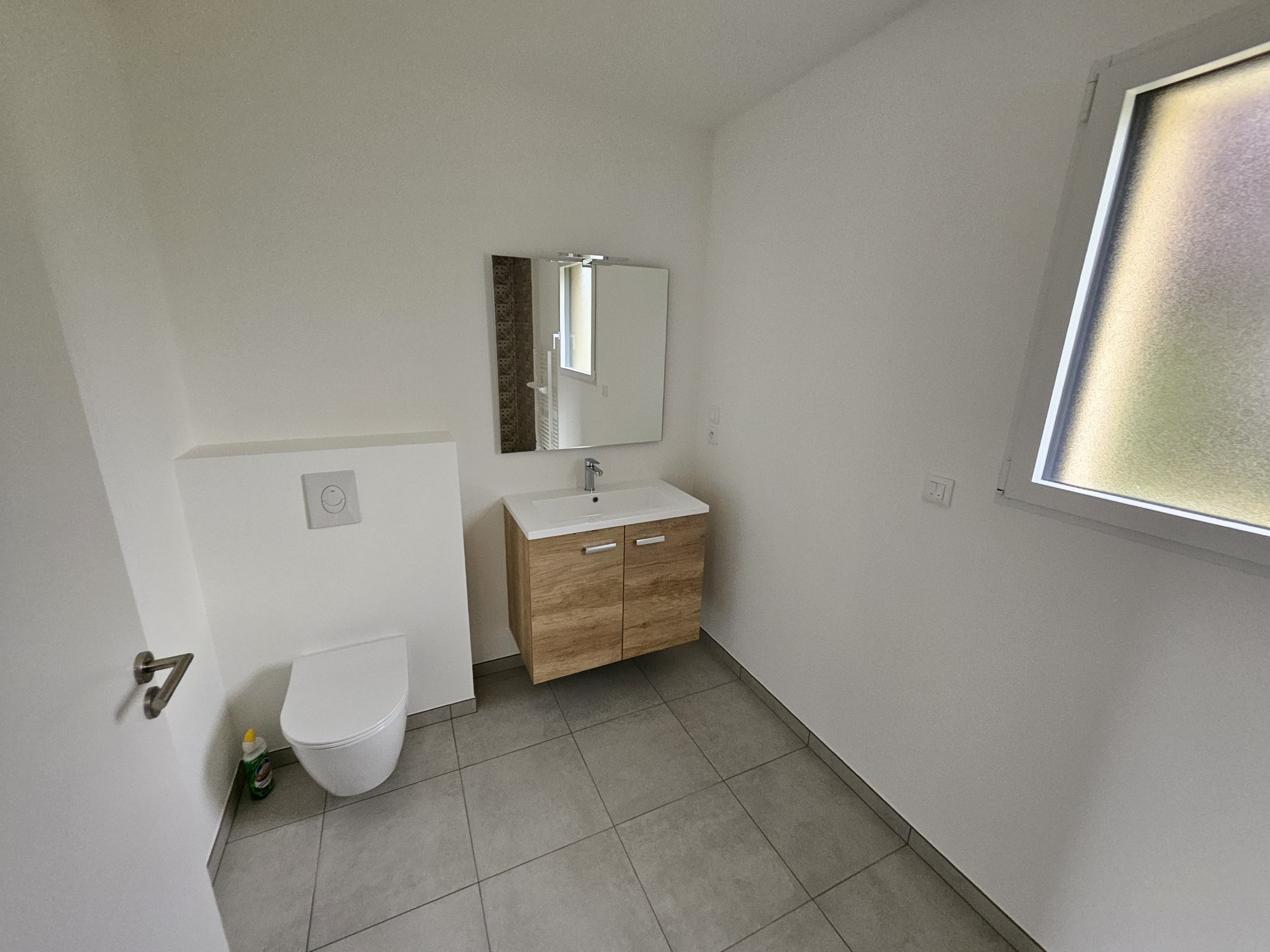Après – Salle de bains moderne dans l’extension de 21 m² à Melesse, avec meuble vasque en bois et WC suspendu
