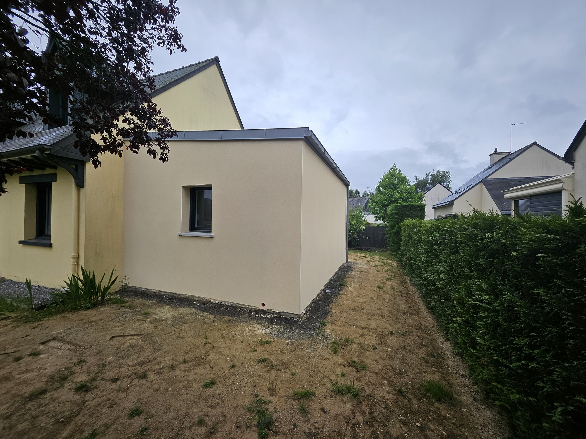 Après – Extension 21 m² à Melesse, vue latérale avec toiture plate et intégration aux façades existantes